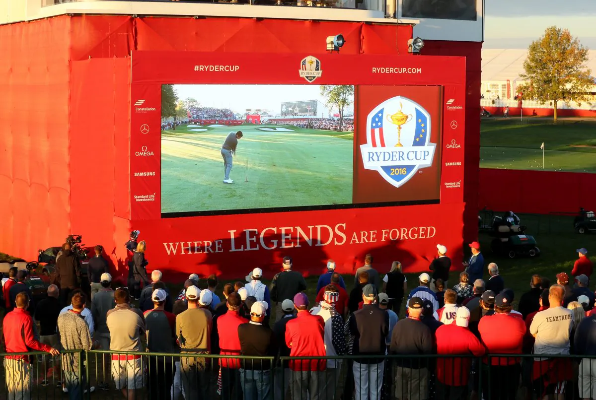 Fans watch a video board during morning foursome matches of the 2016 Ryder Cup at Hazeltine National Golf Club. (Andrew Redington/Getty Images)