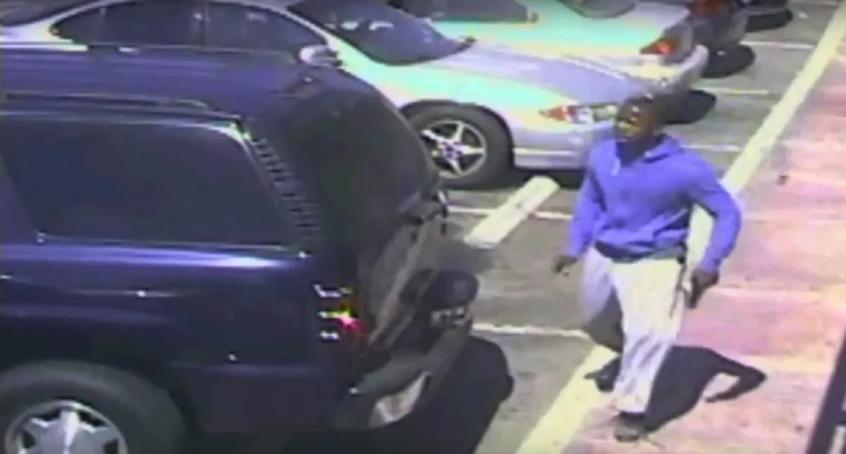 A suspect holding what appears to be a gun in the moments before he was fatally shot by officers in a police killing that has generated widespread protests. (Los Angeles Police Department via AP)