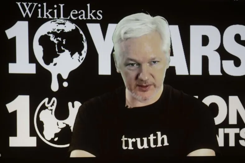 WikiLeaks founder Julian Assange participates via video link at a news conference marking the 10th anniversary of the secrecy-spilling group in Berlin, Germany, Tuesday, Oct. 4, 2016. Assange said that WikiLeaks plans to start a series of publications this week, but wouldn’t specify the timing and subject. (AP Photo/Markus Schreiber)