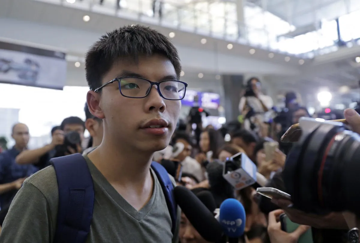 Pro-democracy activist Joshua Wong speaks to media after arriving at Hong Kong airport from Bangkok on Oct. 5, 2016. (AP Photo/Kin Cheung)