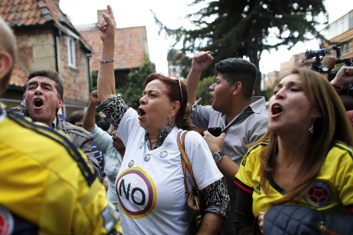 Opponents to the peace deal signed between the Colombian government and rebels of the Revolutionary Armed Forces of Colombia, FARC, celebrate the results of the referendum in Bogota, Colombia, on Oct. 2. (AP Photo/Ariana Cubillos)