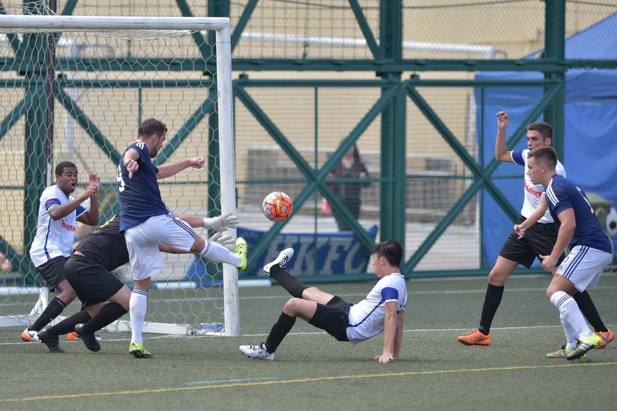 Goalmouth action between Club Wanderers (in blue top) and French Kiss in the Yau Yee League division 1 match at Sports Road on Sunday Oct 2, 2016. (Bill Cox/Epoch Times)