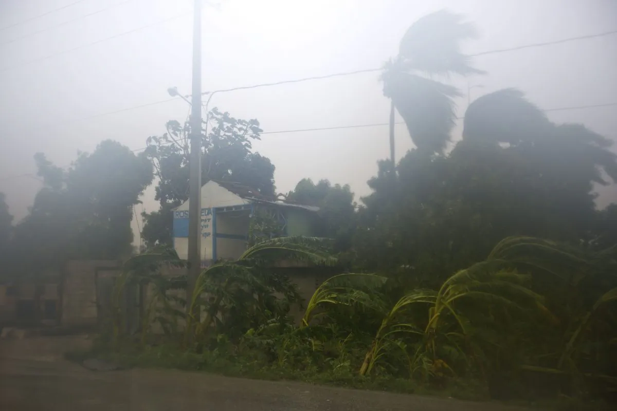 A house with its roof torn off by the winds caused by Hurricane Matthew stands in Leogane, Haiti. Tuesday, Oct. 4, 2016. Matthew slammed into Haiti's southwestern tip with howling, 145 mph winds tearing off roofs in the poor and largely rural area, uprooting trees and leaving rivers bloated and choked with debris. (AP Photo/Dieu Nalio Chery)