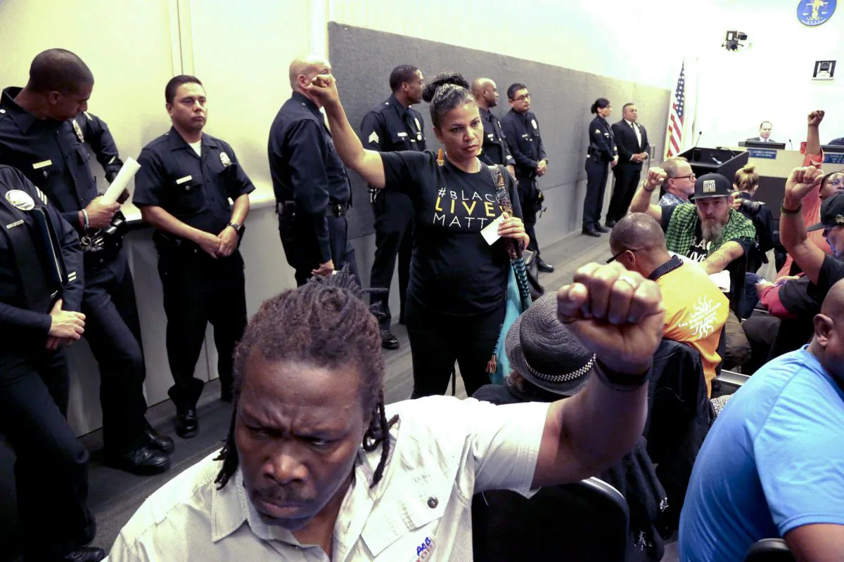 Black Lives Matter protesters demonstrate inside the board of Police Commissioners meeting in Los Angeles on Oct. 4, 2016. Police released surveillance video showing an 18-year-old black suspect running from police while holding what appears to be a gun in his left hand just before he was fatally shot by officers in a death that has generated protests. (AP Photo/Nick Ut)