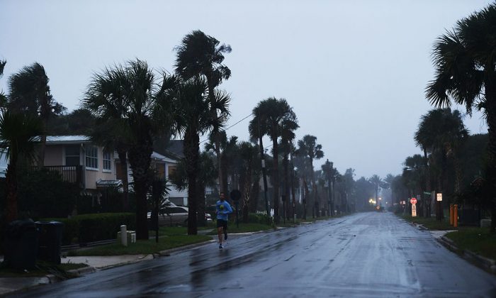 A local resident jogs at dawn in a coastal line neighborhood ahead of hurricane Matthew in Jacksonville, Florida, on Oct. 6, 2016. (Jewel Samad/AFP/Getty Images)