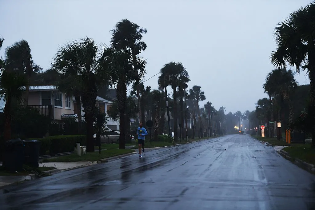 A local resident jogs at dawn in a coastal line neighborhood ahead of hurricane Matthew in Jacksonville, Florida, on Oct. 6, 2016. (Jewel Samad/AFP/Getty Images)