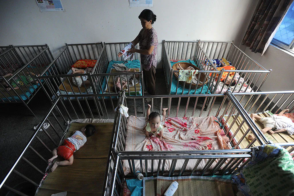A Chinese worker cares for the babies at an orphanage in Wuhu, in eastern China's Anhui province on August 7, 2009. (AFP/AFP/Getty Images)
