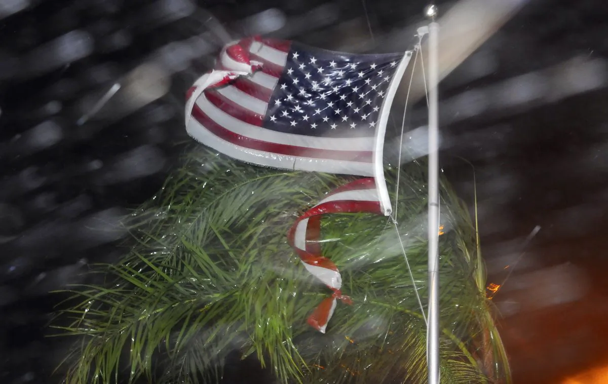 An American flag is ripped to shreds from heavy rain and wind from Hurricane Matthew early Friday, Oct. 7, 2016 in Cape Canaveral, Fla. (Craig Rubadoux/Florida Today via AP)