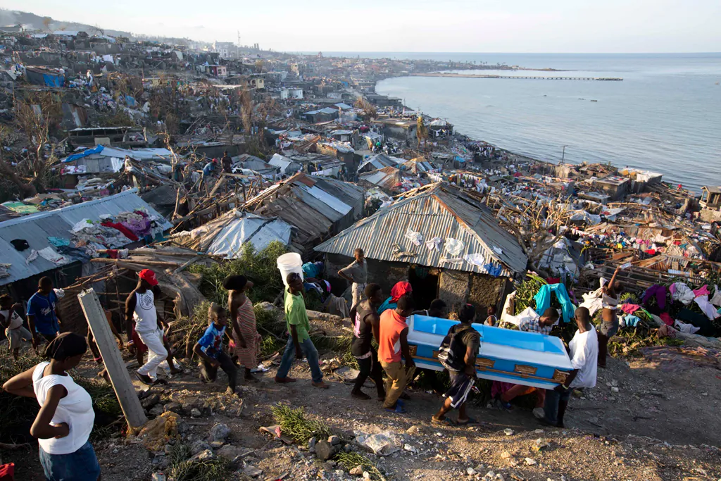 Residents carry a coffin containing the remains of a pregnant woman, a victim of Hurricane Matthew, in Jeremie, Haiti, on Oct. 7, 2016. (AP Photo/Dieu Nalio Chery)