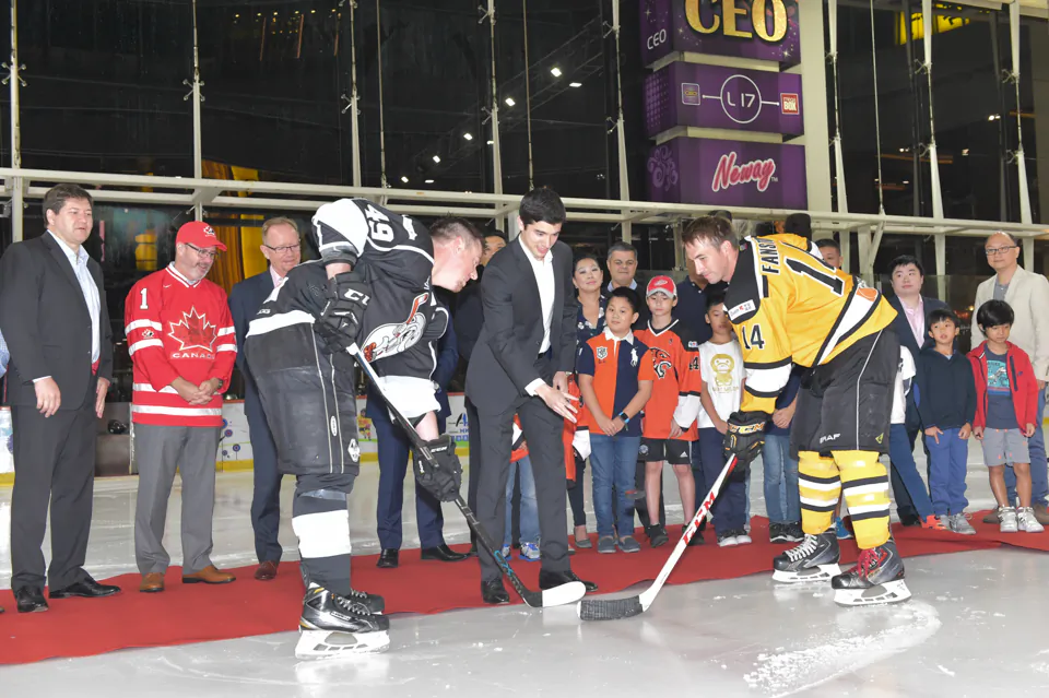 Puck-drop by Stefan Pouliot of main Sponsor Quam Financial Services under the watchful eye of CIHL Officials, Jeff Nankivell, Canada Consul General for Hong Kong and Macau, (wearing Canada Jersey) and other guests to start the 2016-17 season for the Hong Kong CIHL league at Mega Ice on Thursday Oct 6, 2016. (Bill Cox/Epoch Times)