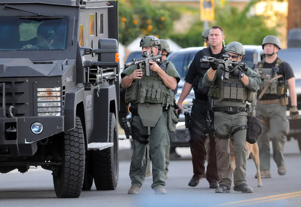 Authorities search an area following a shooting that killed several people at a social services center in San Bernardino, Calif., on Dec. 2, 2015. (James Quigg/The Daily Press via AP)