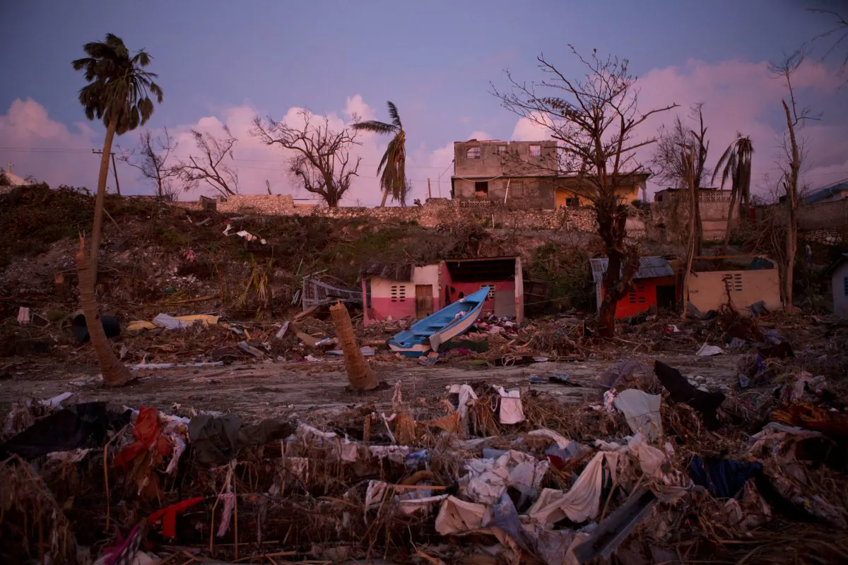 A boat lies washed up amidst Haitian army buildings damaged by Hurricane Matthew, in a seaside fishing neighborhood in Port Salut, Haiti, Sunday, Oct. 9, 2016.  (AP Photo/Rebecca Blackwell)