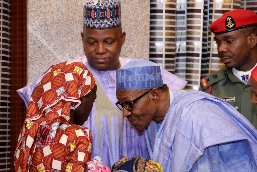 Nigerian President Mohammadu Buhari meets with a woman rescued from Boko Haram, in Abuja, on May 19, 2016. (Stringer/AFP/Getty Images)