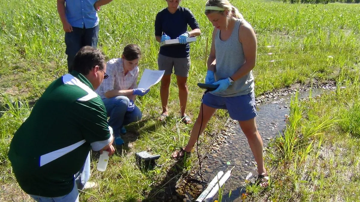A file photo of students testing the contents of a stream at the Notre Dame Linked Experimental Ecosystem Facility for evidence of genetically modified organisms (GMOs). Rice University scientists are developing the light transmission spectrometer, which can detect GMOs. (Arial Shogren)