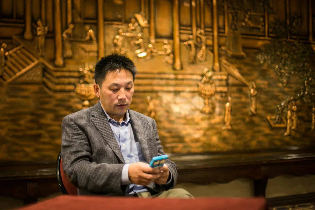 Li Hongkuan uses the Chinese social media app WeChat, in Flushing, New York, on Oct. 4. WeChat offers the potential for activists to disseminate more subversive content, but with a more limited audience, in China. (Matthew Robertson/Epoch Times)