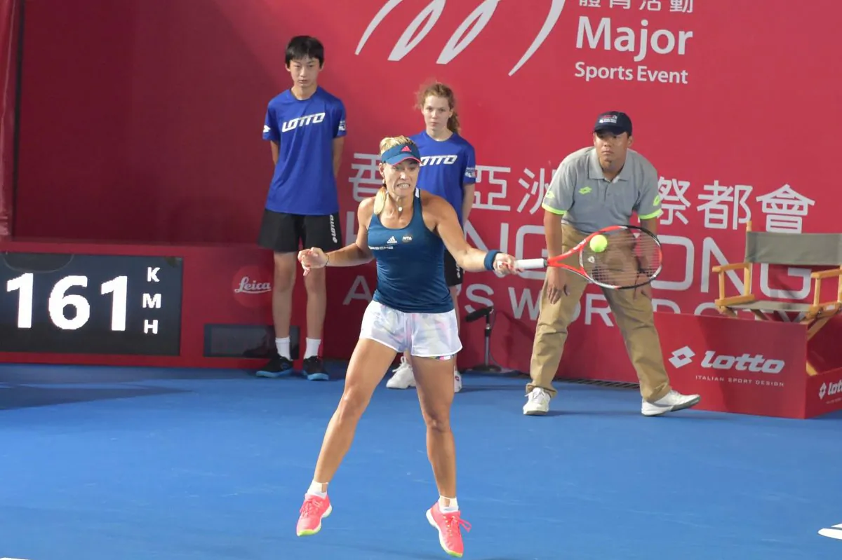 World No 1 Angelique Kerber of Germany hits a return to Maria Sakkari of Greece in their 1st round match at the Hong Kong Open 2016, at Victoria Park Stadium on Tuesday Oct 11. Kerber won 6/4, 6/4 to meet Louisa Chrico of USA in round 2. (Bill Cox/Epoch Times)