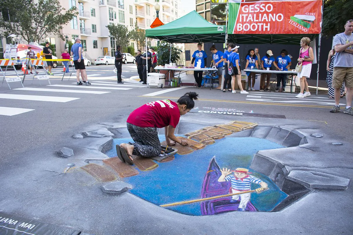 Liliana Mai, an art teacher from Temecula Middle School, creates Gesso Italiano (Italian chalk art) on the street in Little Italy, San Diego, Calif., on Oct. 9, 2016. (Jane Yang/The Epoch Times)