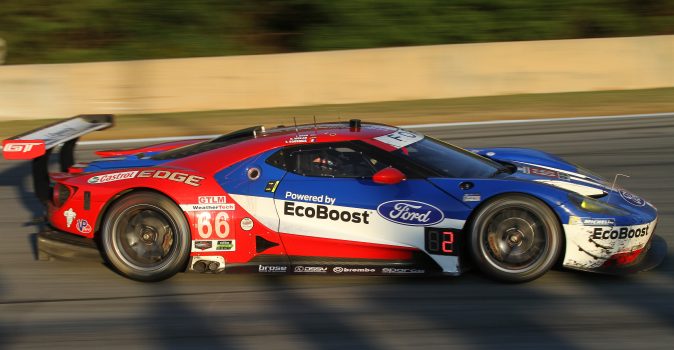 Joey Hand wheels the #66 Ford-Ganasssi Ford GT towards Turn Six, chasing the GTLM class-leading #62 Risi Ferrari as the shadows lengthen. (Chris Jasurek/Epoch Times)