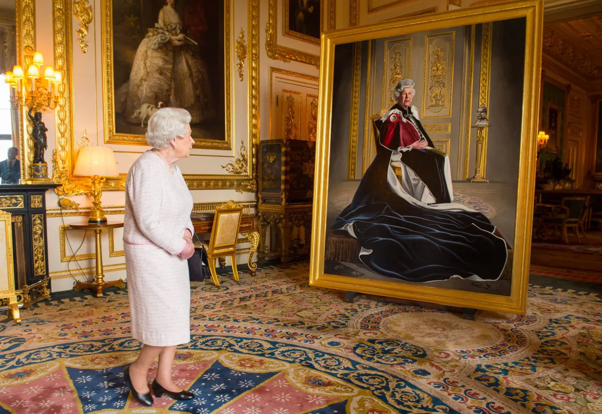 Queen Elizabeth II views a portrait of herself by British artist Henry Ward which has been unveiled at Windsor Castle in Windsor, England, on Oct. 14, 2016, marking six decades of patronage to the British Red Cross. The Queen is the longest-serving patron of the charity, which supports people in crisis in the UK and overseas. (Dominic Lipinski - WPA Pool/Getty Images)
