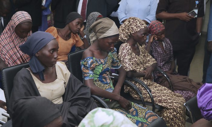In this photo released by the Nigeria State House, freed Chibok school girls sit during a meeting with Nigeria Vice President ,Yemi Osinbajo, in Abuja,, Nigeria, Thursday, Oct. 13, 2016. Twenty-one of the Chibok schoolgirls kidnapped by Boko Haram more than two years ago were freed Thursday in a swap for detained leaders of the Islamic extremist group — the first release since nearly 300 girls were taken captive in a case that provoked international outrage. (Sunday Aghaeze/Nigeria State House via AP)