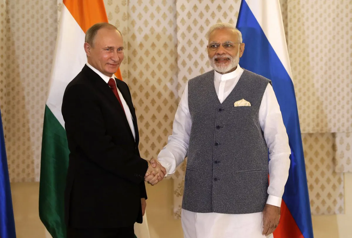 A file image of Indian Prime Minister Narendra Modi (right) shaking hands with Russian President Vladimir Putin prior to their annual bilateral meeting, on the sidelines of the BRICS summit in Goa, India, on Oct. 15, 2016. (Manish Swarup/AP Photo)