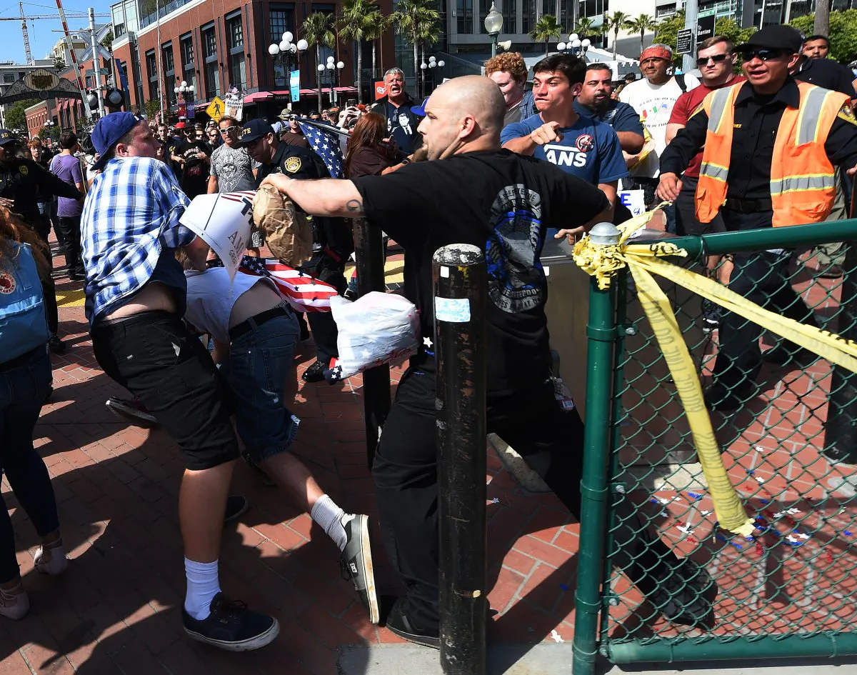 Protesters and supporters of Republican presidential nominee Donald Trump fight during a rally outside Trump's event in San Diego, California, on May 27, 2016.  (Mark Ralston/AFP/Getty Images)
