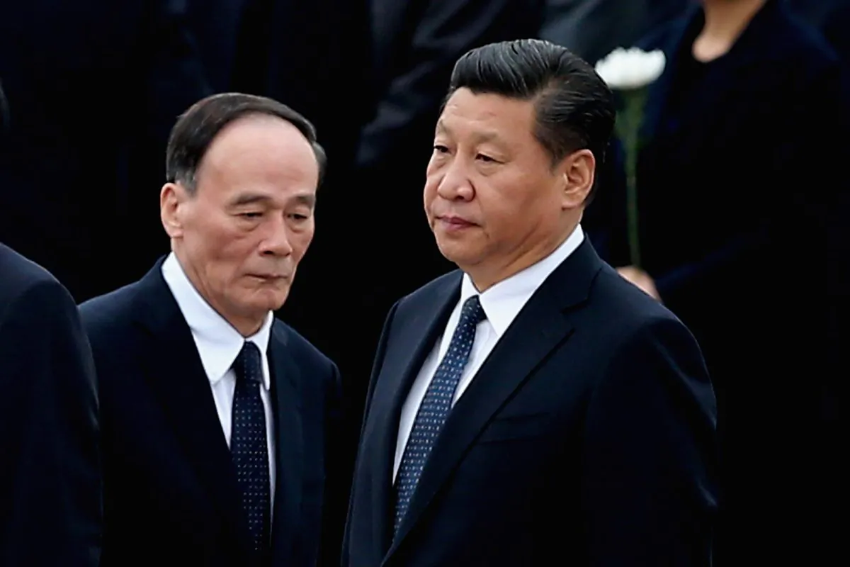 BEIJING, CHINA - SEPTEMBER 30:  Chinese President Xi Jinping (R) and Secretary of the Central Commission for Discipline Inspection Wang Qishan (L) arrive the Monument to the People's Heroes during a ceremony marking Martyr(degrees)?s Day at Tiananmen Square on September 30, 2014 in Beijing, China. China's top legislature approved September 30 as the Martyrs' Day last month.  (Photo by Feng Li/Getty Images)