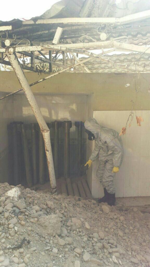 A man in a protective suit investigates a chemical weapons cache, captured in mid-October from ISIS in Qayarah, Iraq. (Ed Alexander/BLACKOPS Cyber)
