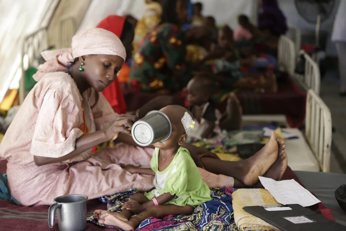 A mother feeds her malnourished child at a feeding center run by Doctors Without Borders in Maiduguri, Nigeria, on Aug. 29, 2016. (AP Photo/Sunday Alamba)
