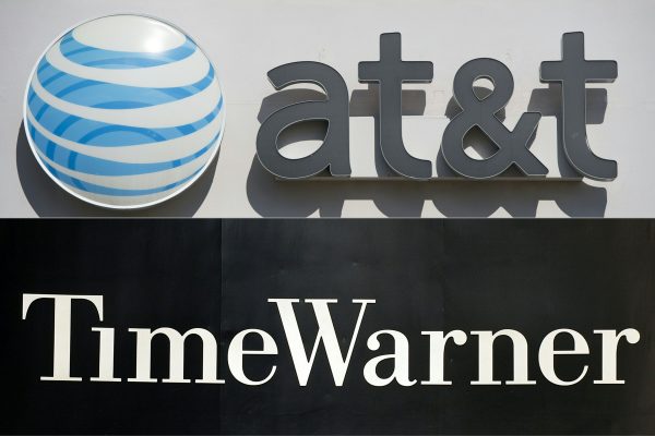 An AT&T logo at a cellphone store in Springfield, Va., on Oct. 23, 2014, and the Time Warner company logo on the front of the headquarters building in New York on Nov. 24, 2003. (Saul Loeb; Stan Honda/AFP/Getty Images)