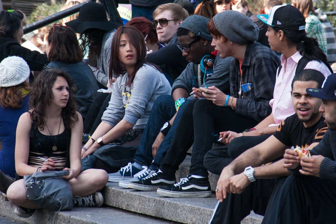 Teens smoke on the steps of Union Square park in New York on March 8, 2012. (Benjamin Chasteen/Epoch Times)