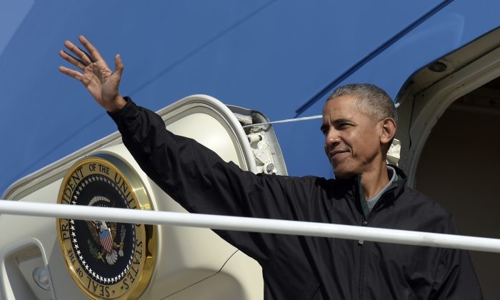 President Barack Obama waves from the top of the steps of Air Force One at Andrews Air Force Base in Md., on Oct. 23, 2016. (AP Photo/Susan Walsh)