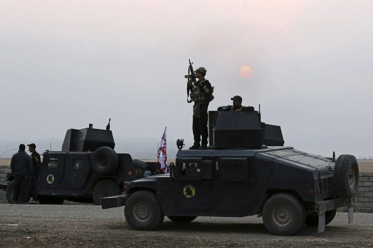 Iraq's elite counterterrorism forces prepare to attack Islamic State positions as fighting to retake the extremist-held city of Mosul entered its second week, in the village of Tob Zawa, outside Mosul, Monday, Oct. 24, 2016. A convoy of special forces advanced toward the village of Tob Zawa, Monday, encountering roadside bombs and trading heavy fire with the militants. Loudspeakers on the Humvees blared Iraqi patriotic music as they pushed toward the village. (AP Photo/Khalid Mohammed)