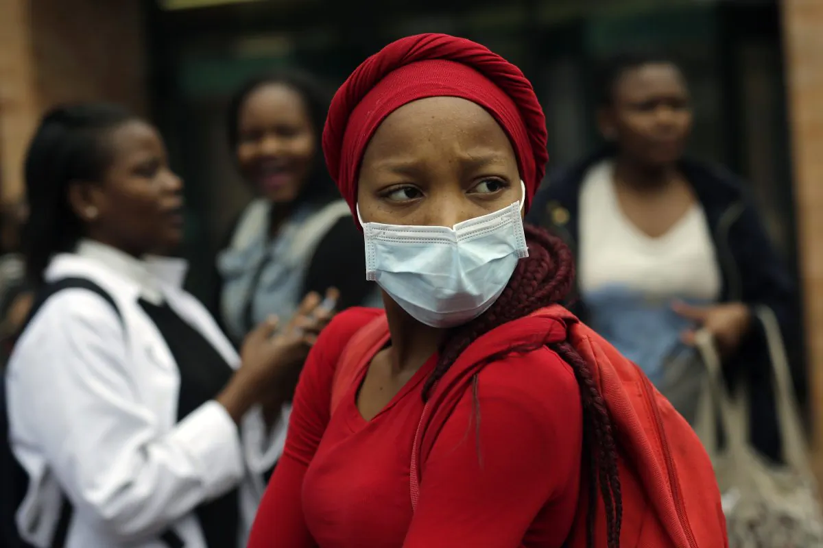 A medical students stares at a line of security officers at the University of the Witwatersrand's medical school in Johannesburg, South Africa, on Oct. 21 2016. (AP Photo/Jerome Delay)