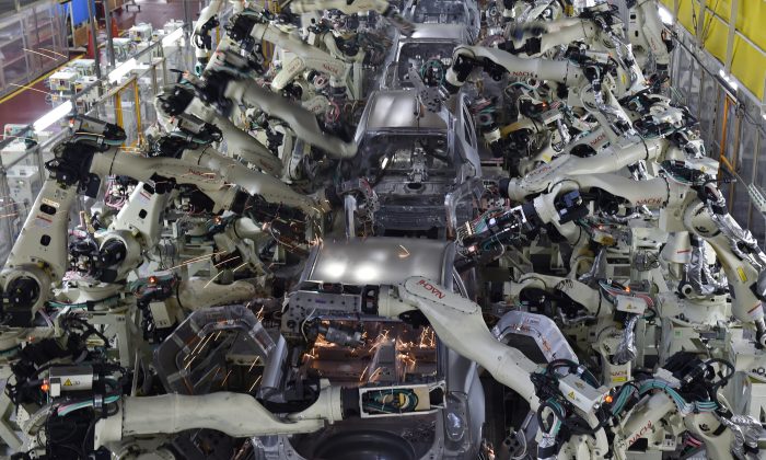 The body welding workshop uses automated welding machine robots to assemble automobile bodies at Toyota Motor's Tsutsumi plant in Toyota, Japan, on Dec. 4, 2014. (Kazuhiro Nogi/AFP/Getty Images)