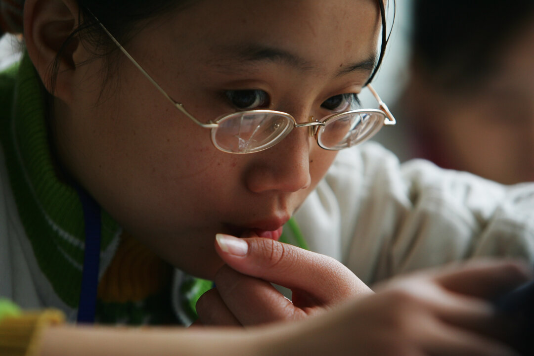 A schoolgirl from the mountain regions studies at an experimental school in Chengdu, capital of southwest China's Sichuan Province, on Nov. 7, 2007. (Guang Niu/Getty Images)