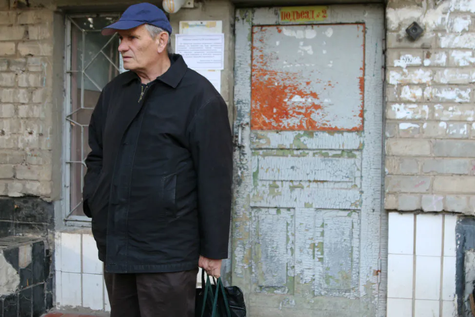Valeriy Ivanenko outside the apartment in Bahmut, Ukraine, where he and his wife, Vira, sought refuge after fleeing their home. (Nolan Peterson/The Daily Signal)