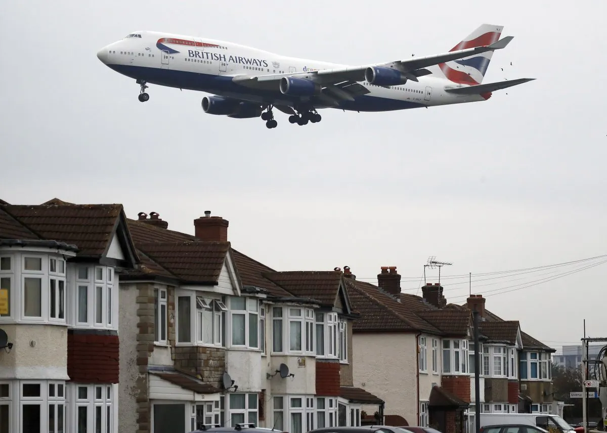 A plane approaches landing over the rooftops of nearby houses at Heathrow Airport in London, Tuesday, Oct. 25, 2016. (AP Photo/Frank Augstein)