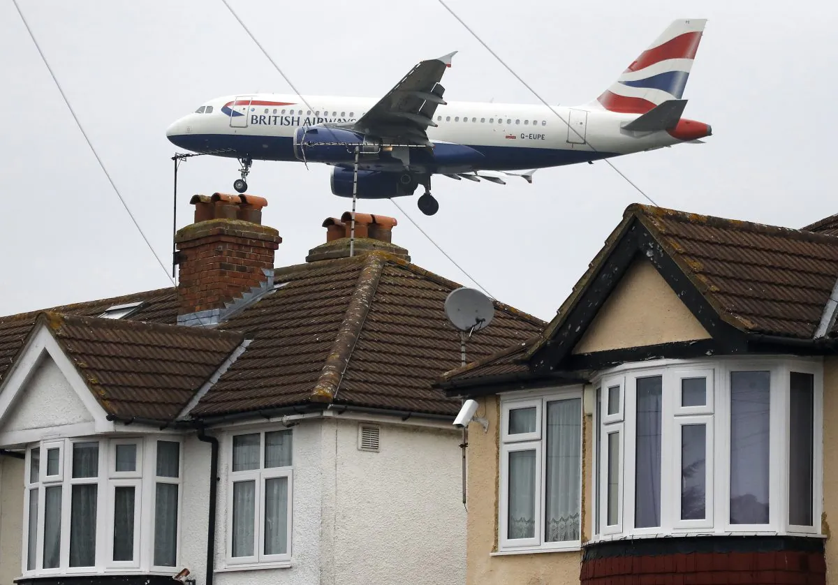 A plane approaches landing over the rooftops of nearby houses at Heathrow Airport in London, on Oct. 25, 2016. (Frank Augstein/AP Photo)