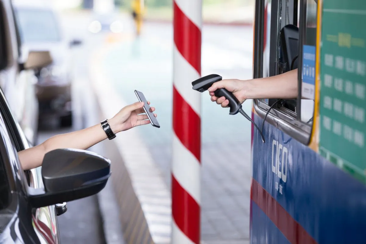 A driver uses Alipay on his smartphone to pay a highway toll, on the Hangzhou-Ningbo Expressway in Hangzhou, Zhejiang province Sept. 21. (STR/AFP/Getty Images)