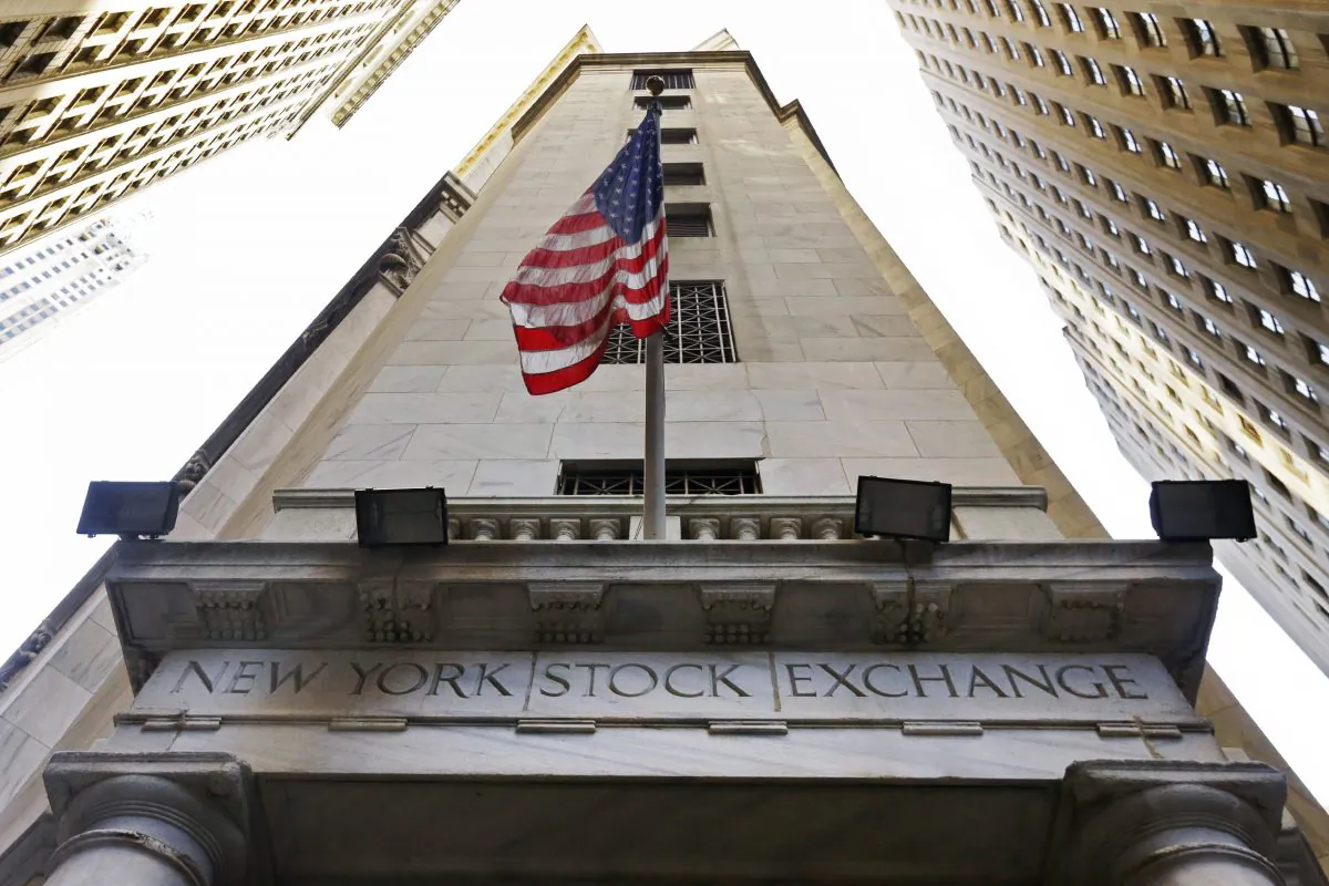 The American flag flies above the Wall Street entrance to the New York Stock Exchange on Nov. 13, 2015. (AP Photo/Richard Drew)