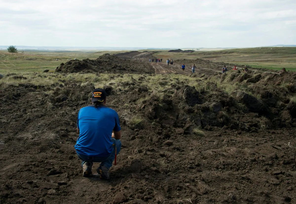 A Native American protestor pauses on land being prepared for the Dakota Access Pipeline (DAPL) near Cannon Ball, North Dakota on Sept. 3. (ROBYN BECK/AFP/Getty Images)