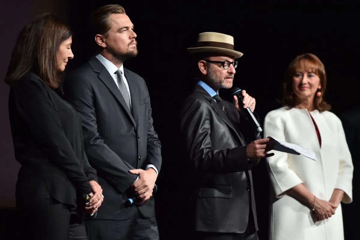 U.S. director Fisher Stevens (2nd R) speaks on stage as (L-R) Paris Mayor Anne Hidalgo, U.S. actor Leonardo DiCaprio and French Environment Minister Segolene Royal listen during the Paris premiere of the documentary film "Before the Flood" at the Theatre du Chatelet in Paris on Oct. 17, 2016. (Christophe Archambault/AFP/Getty Images)