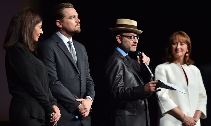 U.S. director Fisher Stevens (2nd R) speaks on stage as (L-R) Paris Mayor Anne Hidalgo, U.S. actor Leonardo DiCaprio and French Environment Minister Segolene Royal listen during the Paris premiere of the documentary film "Before the Flood" at the Theatre du Chatelet in Paris on Oct. 17, 2016. (Christophe Archambault/AFP/Getty Images)