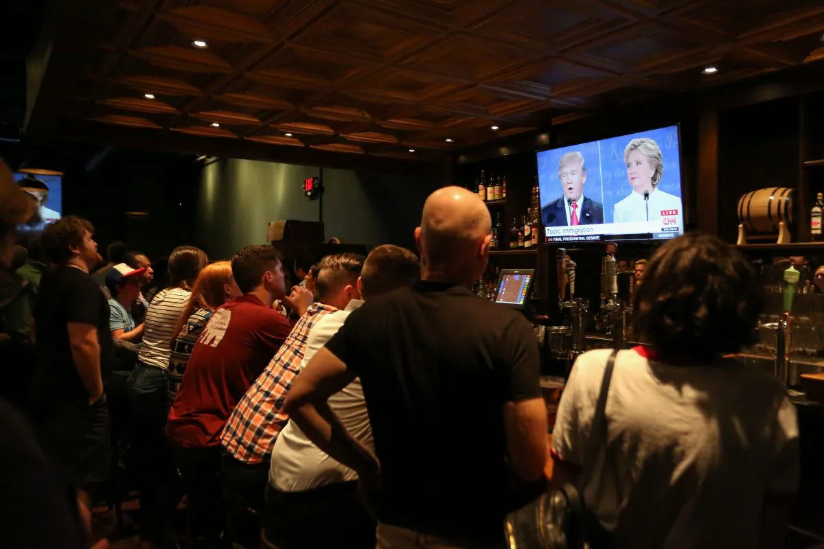 People watch the third presidential debate between Democratic candidate Hillary Clinton and Republican candidate Donald Trump at Murphy's Tap House in uptown Charlotte, N.C., on Oct. 19, 2016. (Logan Cyrus/AFP/Getty Images)