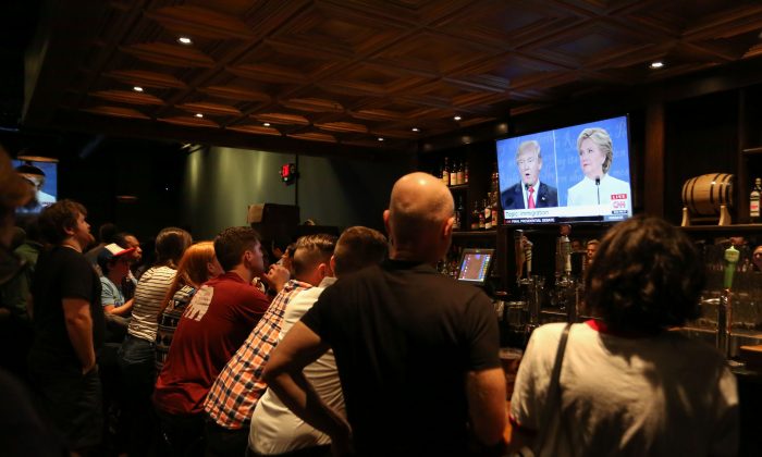 People watch the third presidential debate between Democratic candidate Hillary Clinton and Republican candidate Donald Trump at Murphy's Tap House in uptown Charlotte, N.C., on Oct. 19, 2016. (Logan Cyrus/AFP/Getty Images)