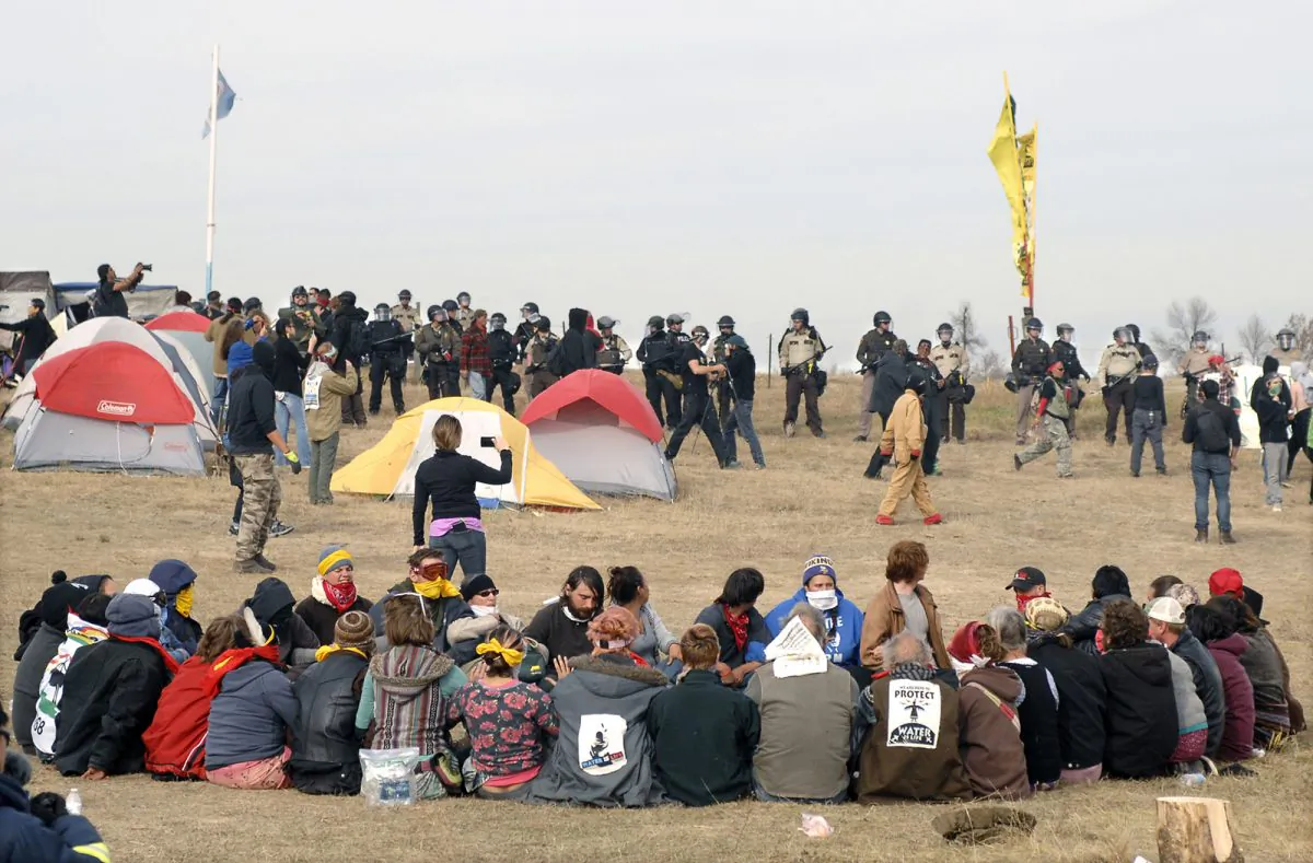 Dakota Access Pipeline protesters sit in a prayer circle at the Front Line Camp in Morton County, N.D., in this file photo. (Mike McCleary/The Bismarck Tribune via AP)