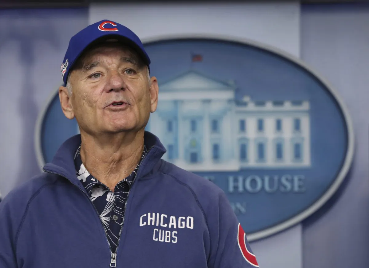 Actor Bill Murray sporting a Chicago Cubs jacket and cap during a brief visit in the Brady Press Briefing Room of the White House in Washington in this Oct. 21, 2016, file photo. MLB.com reports Murray gave a ticketless fellow Cubs fan an extra seat to Game 6 of the World Series on Nov. 1, 2016. (AP Photo/Manuel Balce Ceneta, File)
