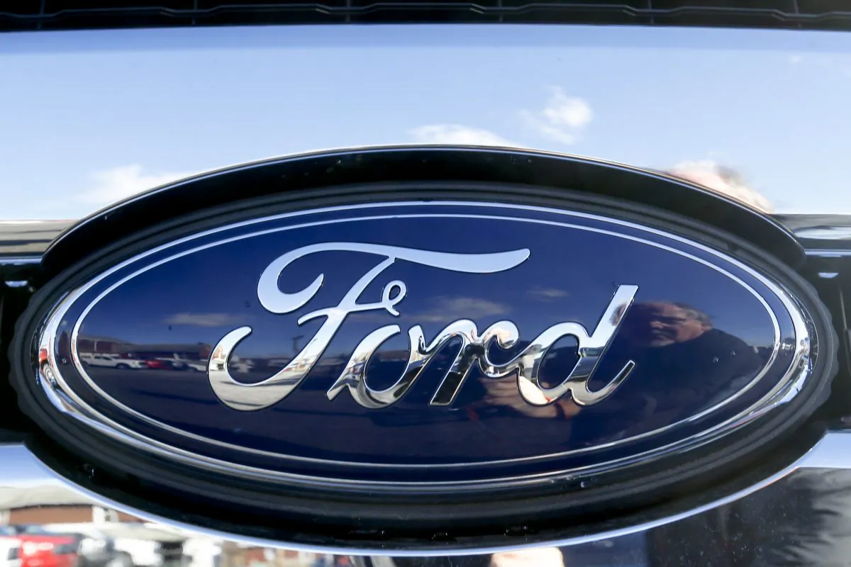 The blue Ford oval badge in the grill of a pickup truck on the sales lot at Butler County Ford in Butler, Pa. on Nov. 19, 2015. Ford’s U.S. sales fell 12 percent in October, a steeper-than-expected drop that lowered the overall industry’s sales. Most automakers reported sales on Nov. 1, 2016, but Ford's results were delayed by a day because of an electrical fire at its Dearborn, Michigan headquarters. (AP Photo/Keith Srakocic)