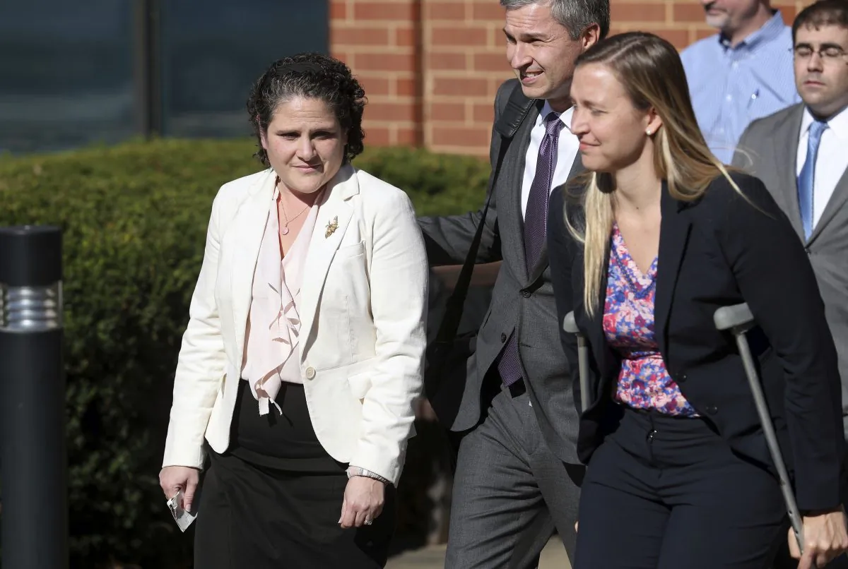 University of Virginia administrator Nicole Eramo, left, leaves the federal courthouse in Charlottesville, Va., with attorney Libby Locke, right, on Friday, Nov. 4, 2016. A federal jury on Friday found Rolling Stone magazine, its publisher and a reporter defamed Eramo in a discredited story about gang rape at a fraternity house of the university. (Ryan M. Kelly /The Daily Progress via AP)